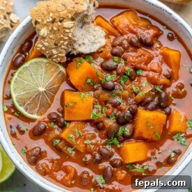 Comforting Sweet Potato Chili 11 Top-down shot of sweet potato chili in a white bowl with lime granish