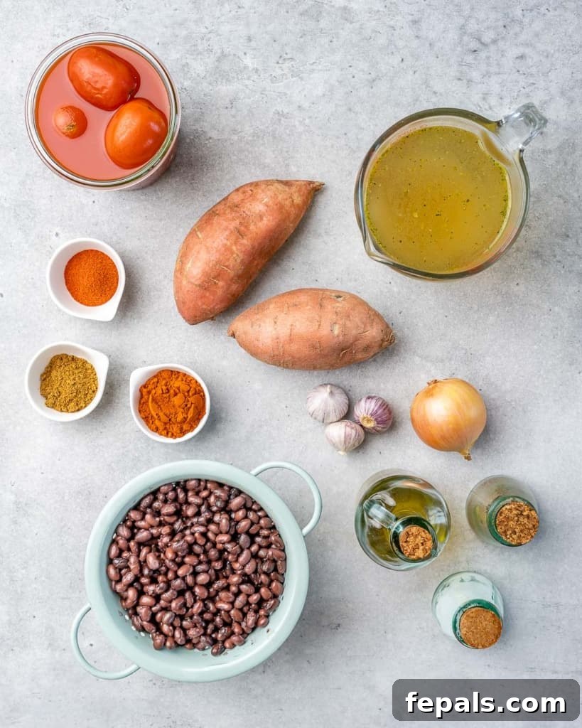 Comforting Sweet Potato Chili 4 A beautiful overhead view showcasing all the fresh and vibrant ingredients for sweet potato chili laid out on a clean surface, ready for preparation.