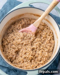 Nutty Oatmeal Morning Fuel 12 Stirring oatmeal in a pot.