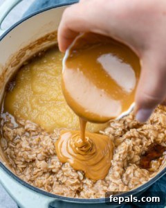 Nutty Oatmeal Morning Fuel 13 Pouring peanut butter onto oats.