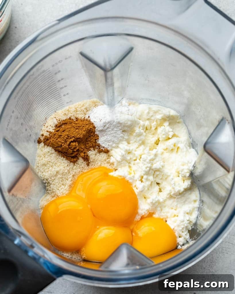 Effortless Keto Waffles 6 A blender filled with the creamy base batter ingredients for keto waffles, ready to be blended.