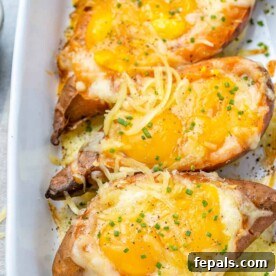 Sweet Potato Sunrise 12 close up view of 3 baked potatoes with eggs in a white dish
