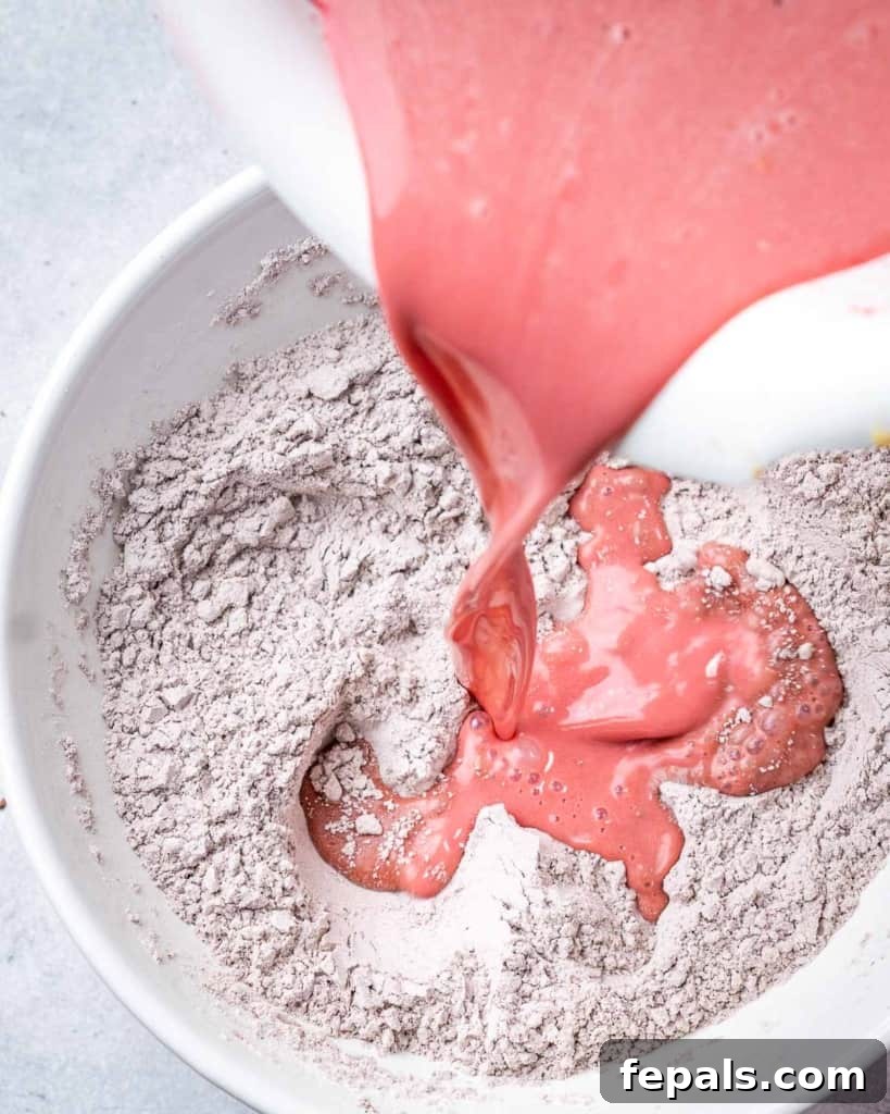 Pouring wet ingredients into dry ingredients. 