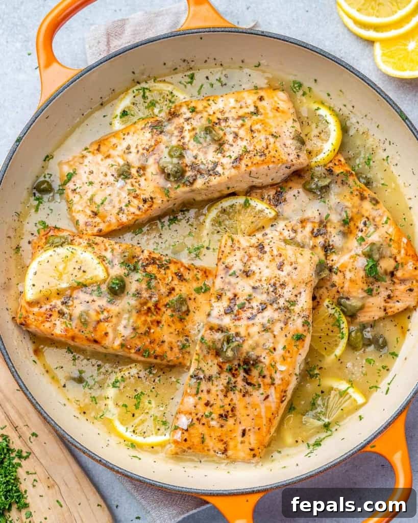 Zesty Salmon Piccata 11 Top view of seared salmon piccata generously covered in a luscious lemon sauce, inviting and beautifully presented.