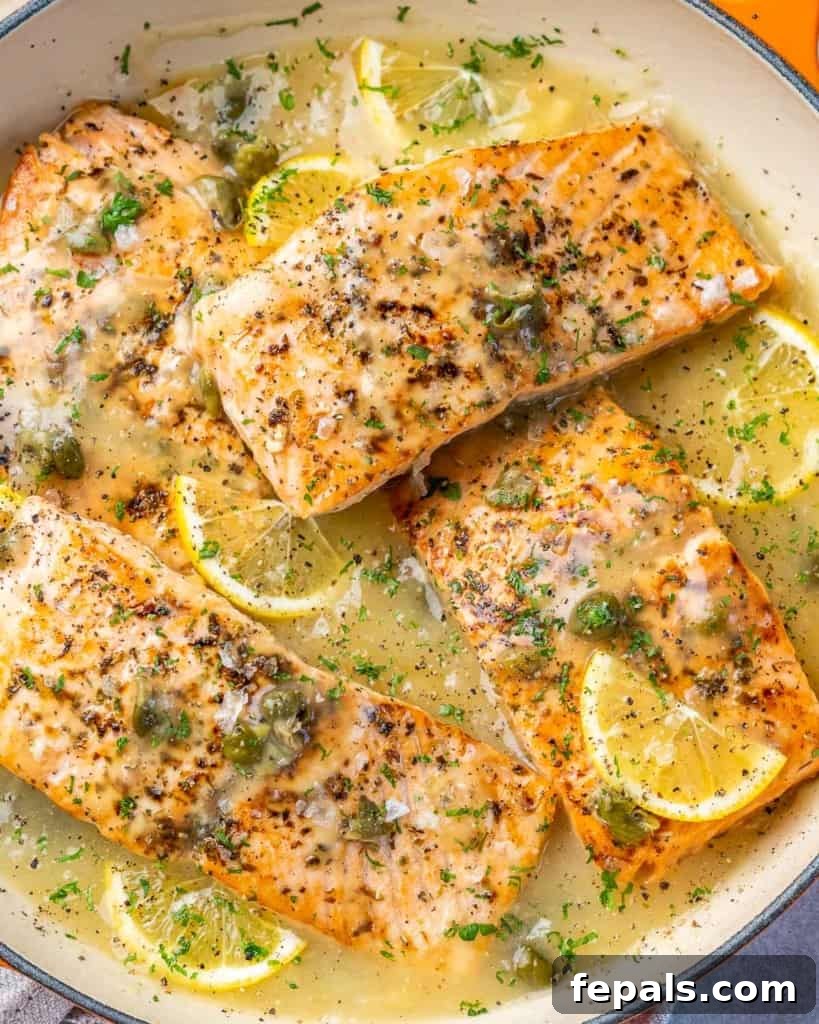 Zesty Salmon Piccata 3 Close-up of perfectly seared salmon fillets coated in a rich, lemony piccata sauce, highlighting the texture and glistening finish.
