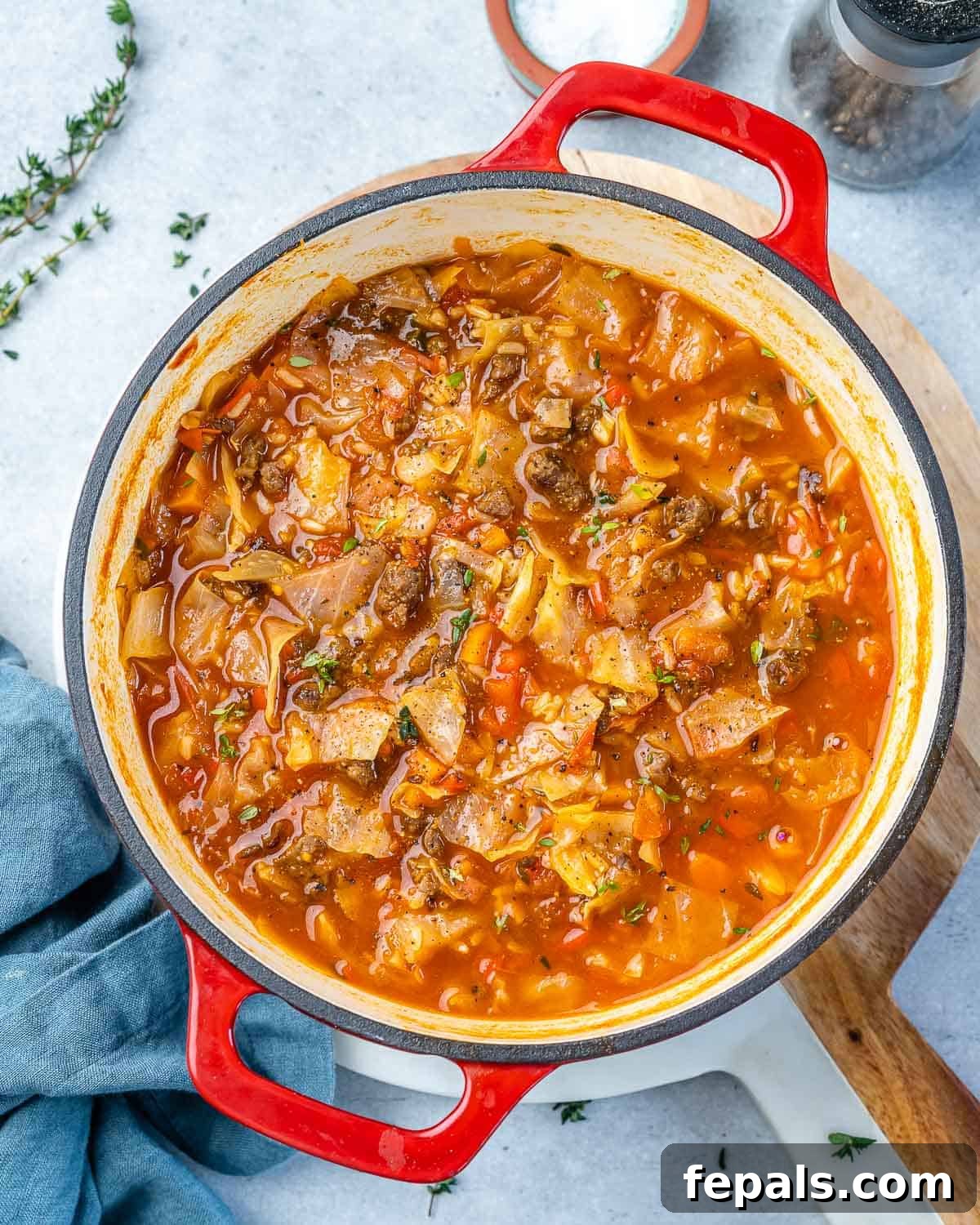 Hearty Unrolled Cabbage Soup 2 Top view of hearty cabbage roll soup in a vibrant red pot, ready to be served.