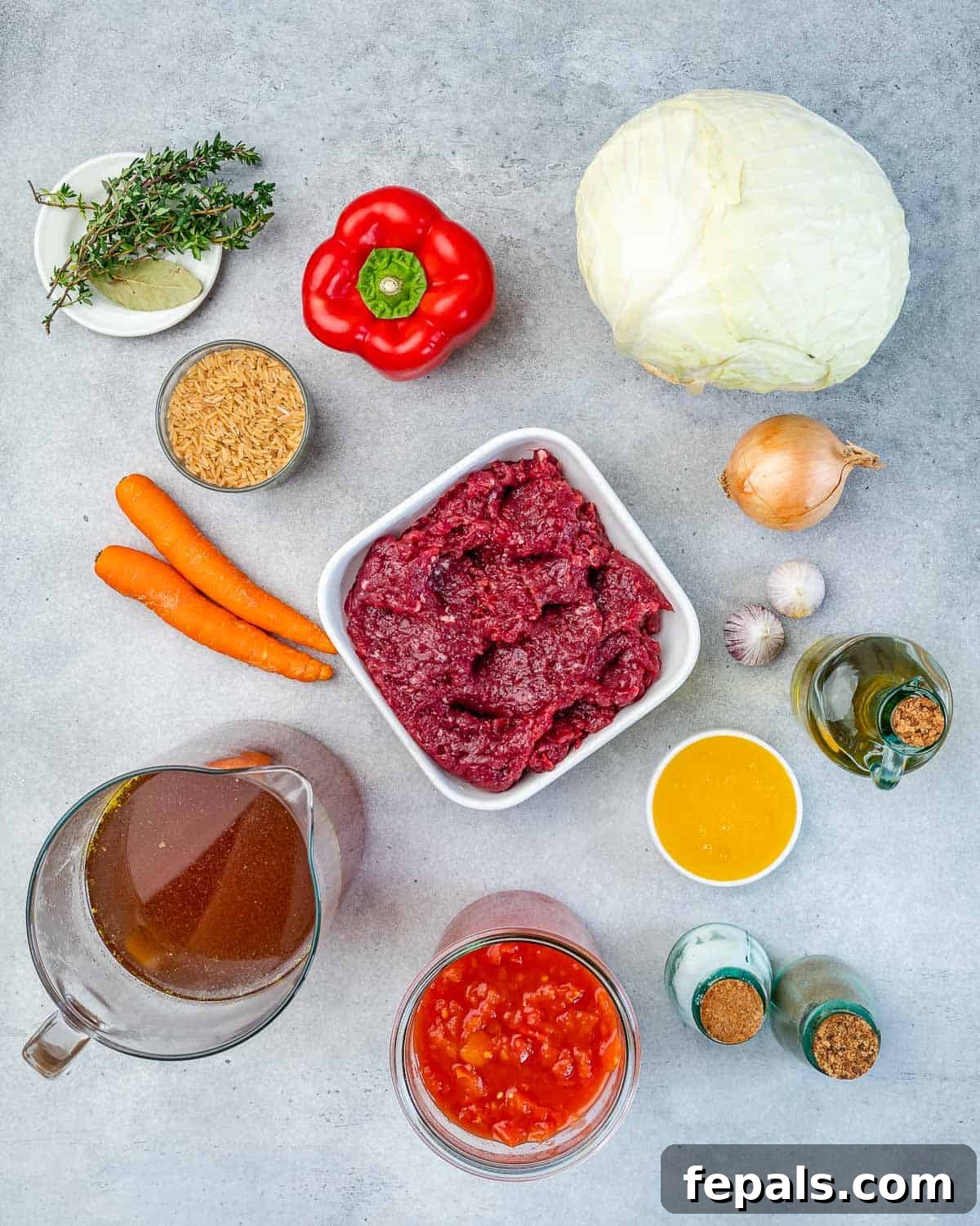 Hearty Unrolled Cabbage Soup 4 Ingredients for healthy cabbage roll soup, neatly arranged on a kitchen counter.