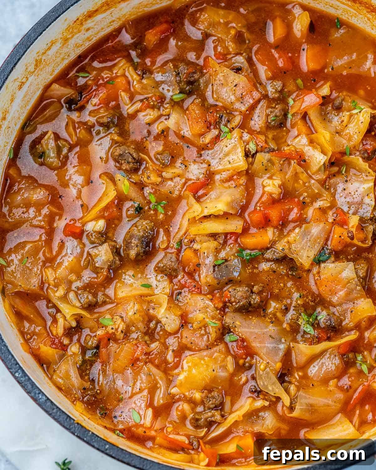 Hearty Unrolled Cabbage Soup 7 A robust Dutch oven filled with steaming, perfectly cooked cabbage roll soup, ready for serving.