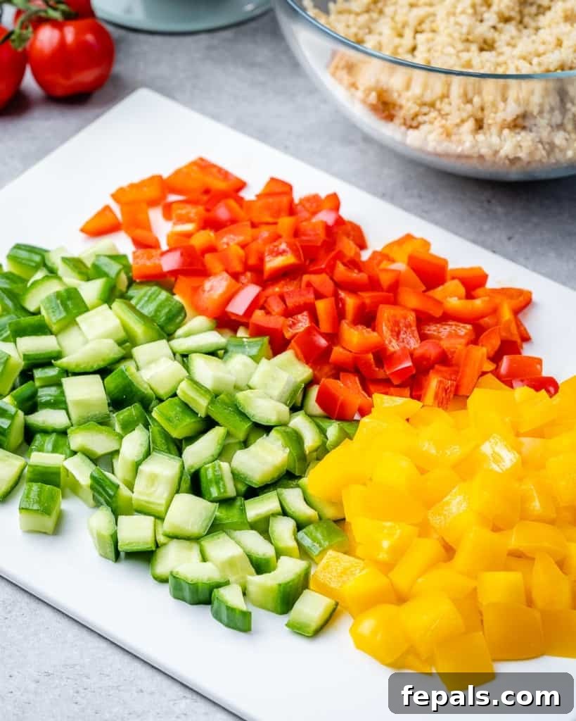 Vibrant Chickpea Quinoa Salad 5 chopped veggies on a white cutting board