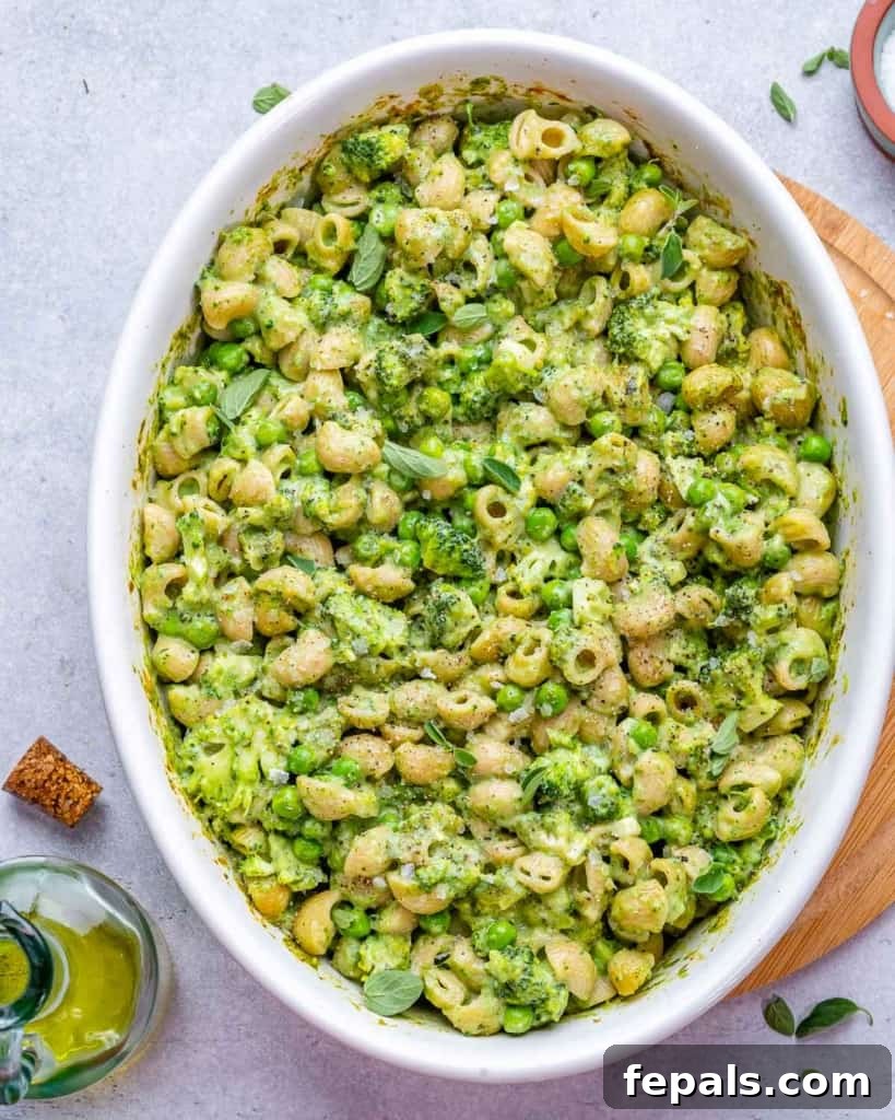 Another top view of green mac and cheese in a white dish, showcasing its vibrant color.