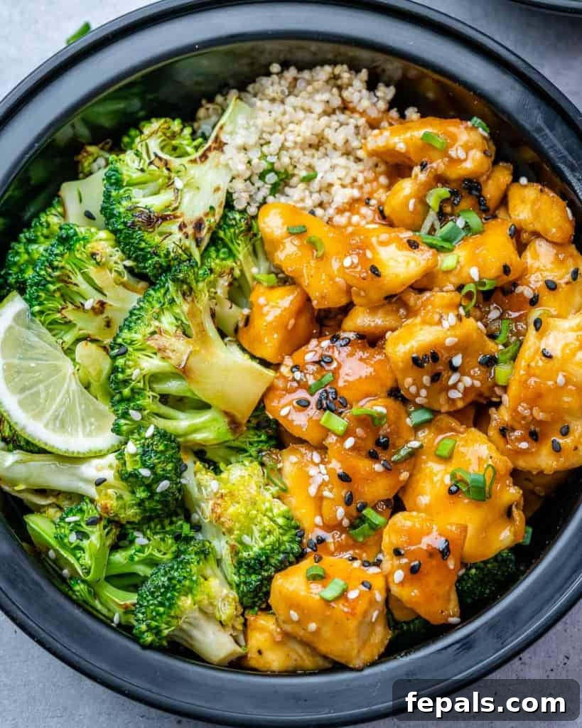 Close up shot of honey garlic chicken with steamed broccoli and fluffy brown rice, ready for meal prepping.