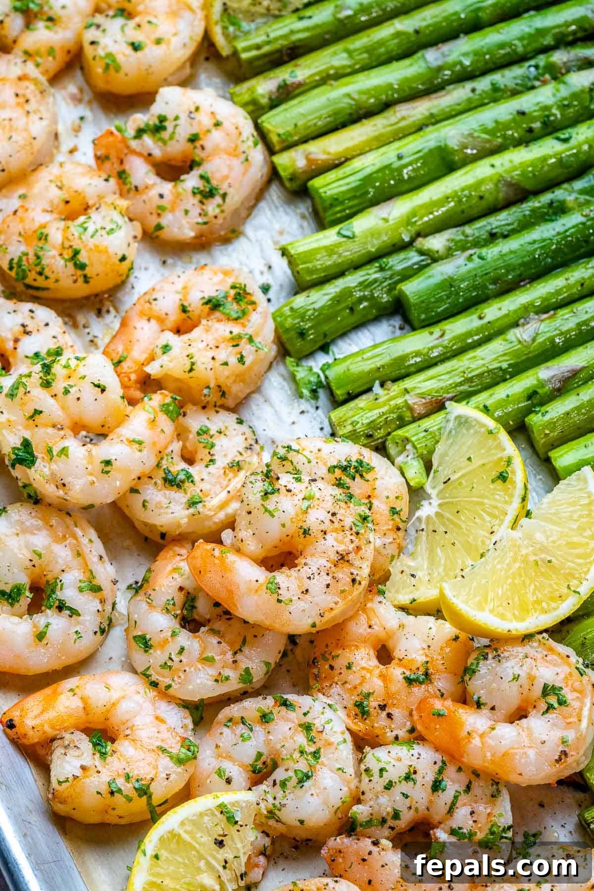 Roasted Garlic Shrimp & Asparagus Sheet Pan Dinner 7 A vibrant close-up of sheet pan garlic lemon shrimp and asparagus, perfectly baked with a slight char and ready to eat.