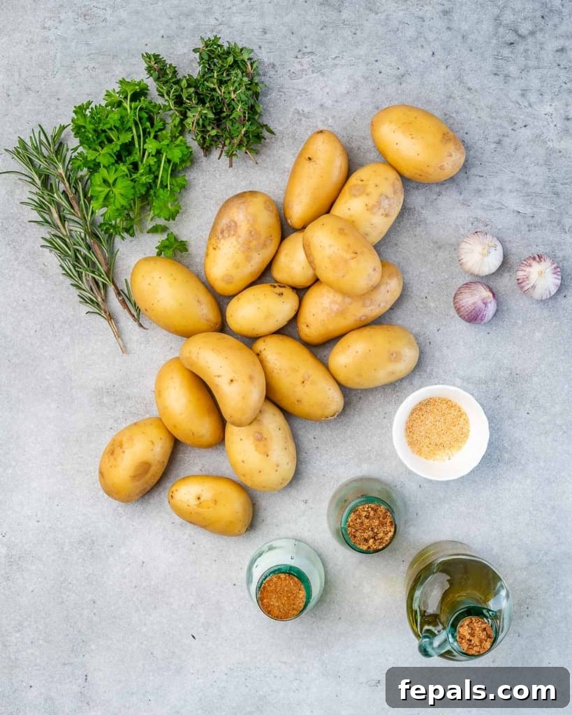 Crispy Garlic Skillet Potatoes 4 Assortment of fresh ingredients for garlic roasted potatoes, including baby potatoes, garlic, olive oil, and herbs.