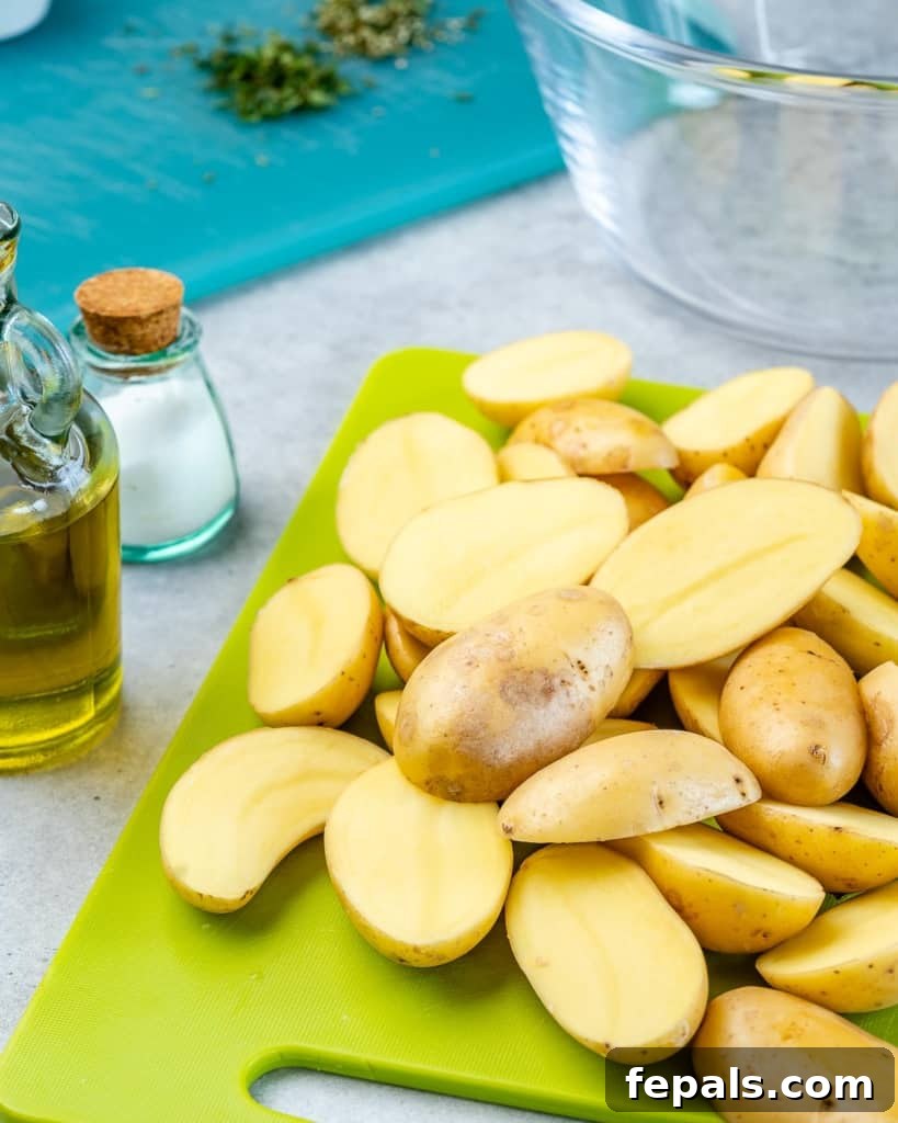 Crispy Garlic Skillet Potatoes 5 Sliced yellow baby potatoes on a cutting board, cut uniformly in halves.