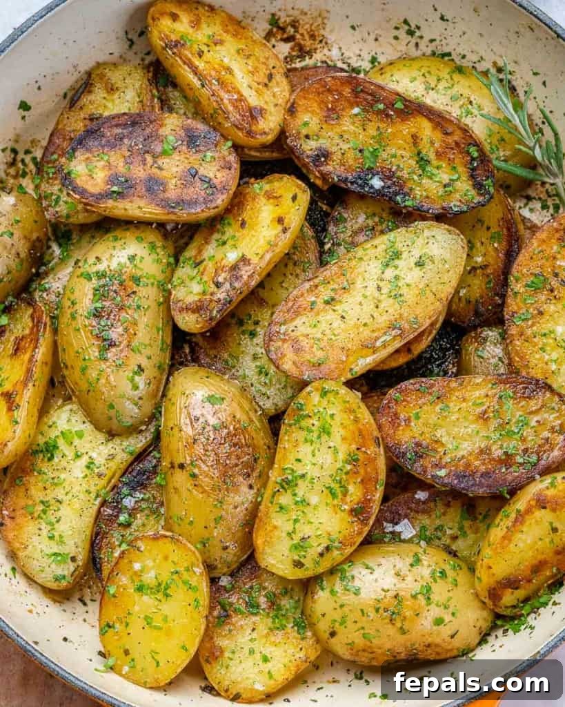 Crispy Garlic Skillet Potatoes 7 Top view of perfectly golden and crispy roasted baby potatoes in a hot skillet, ready to serve.