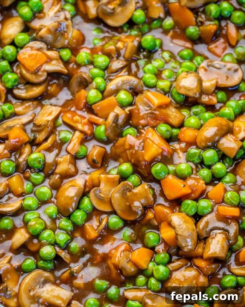 Garden Shepherd's Pie 5 Thickened vegetable filling with mushrooms, carrots, and peas, ready for the mashed potato topping.