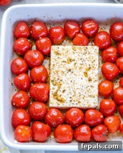 tomatoes and feta in a dish before baking