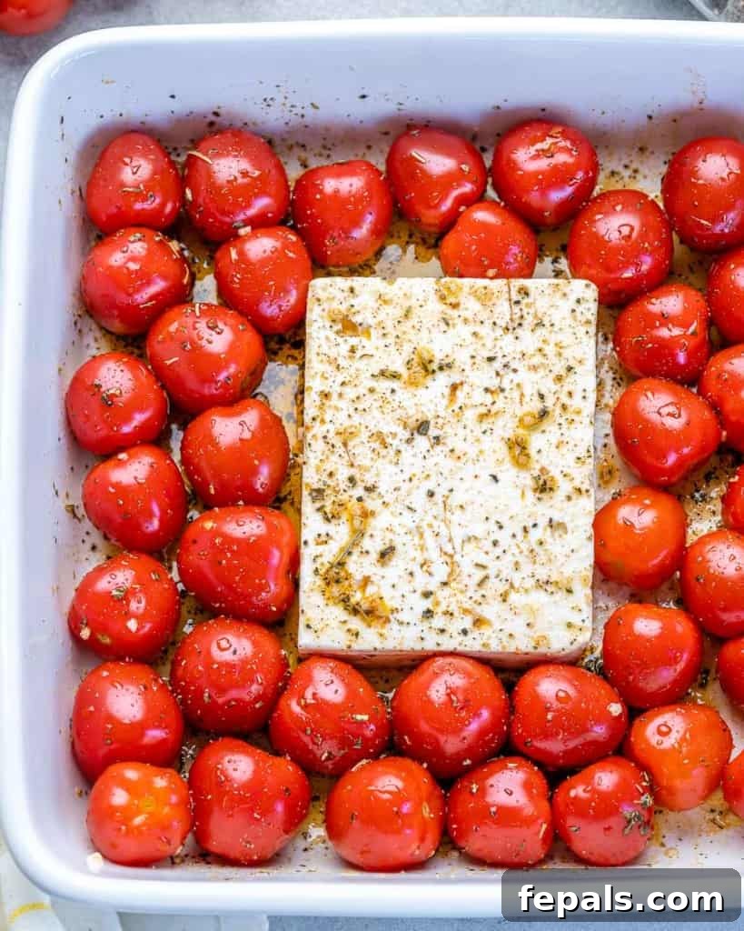 tomatoes and feta in a dish before baking