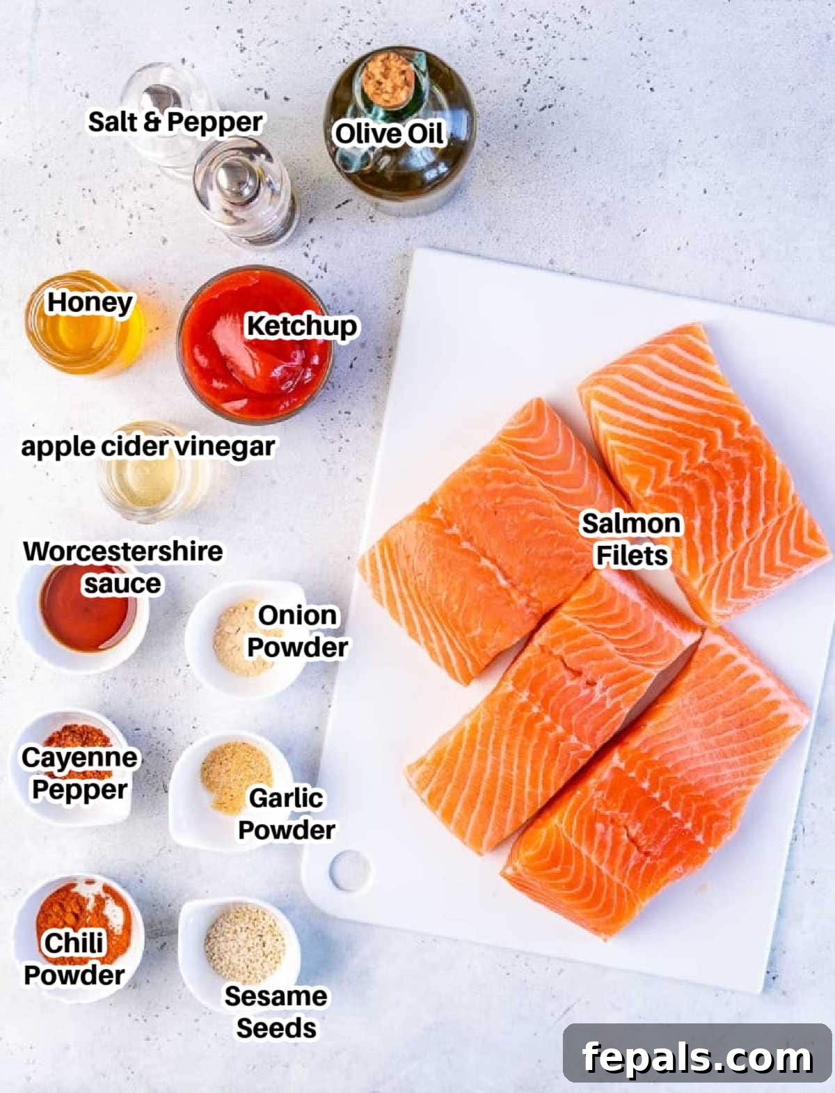 Fire-Kissed Salmon 5 A flat lay image displaying all the fresh and pantry ingredients required for making homemade BBQ salmon, including salmon fillets, various spices, and sauce components.