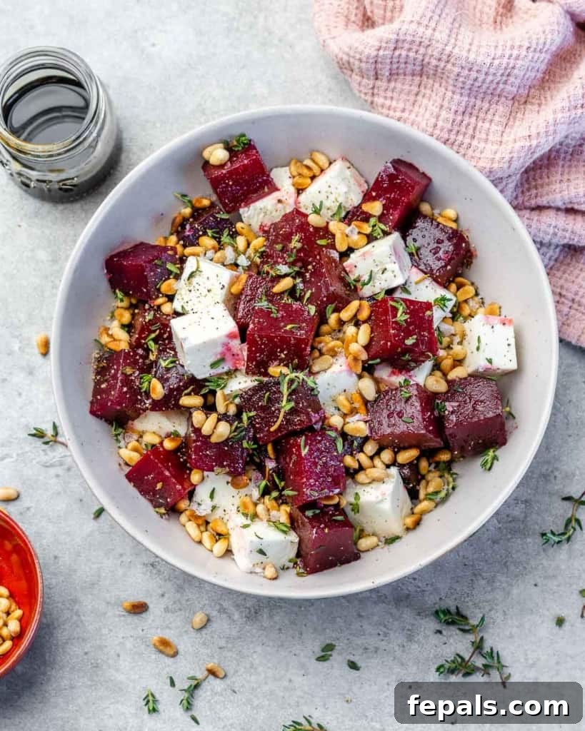 A close-up of the delightful roasted beet salad in a clean white bowl, showcasing the tender beets, crumbled feta, and fresh herbs.