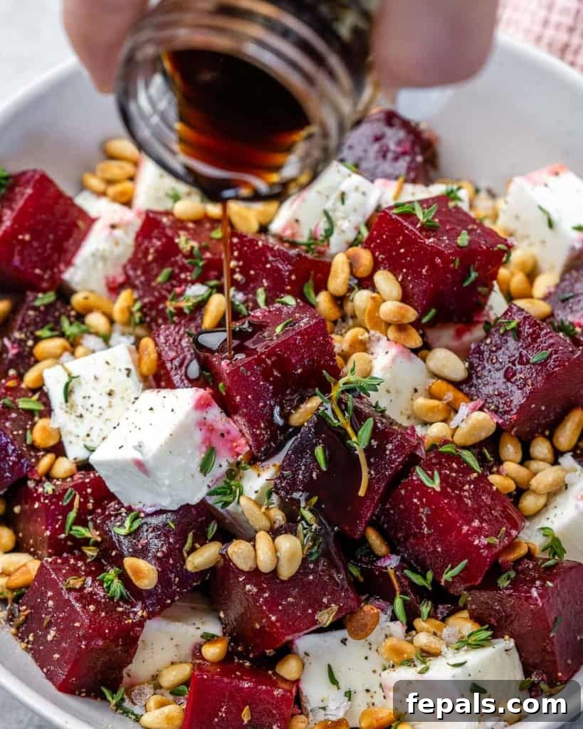 A close-up, inviting view of roasted beet salad in a white bowl, with balsamic vinegar glistening on top, ready to be enjoyed.