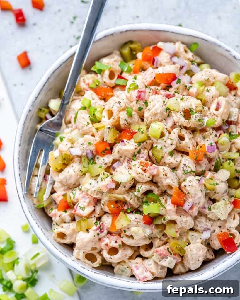 Grandma's Simple Macaroni Salad 2 top view macaroni salad in a white bowl with fresh parsley garnish