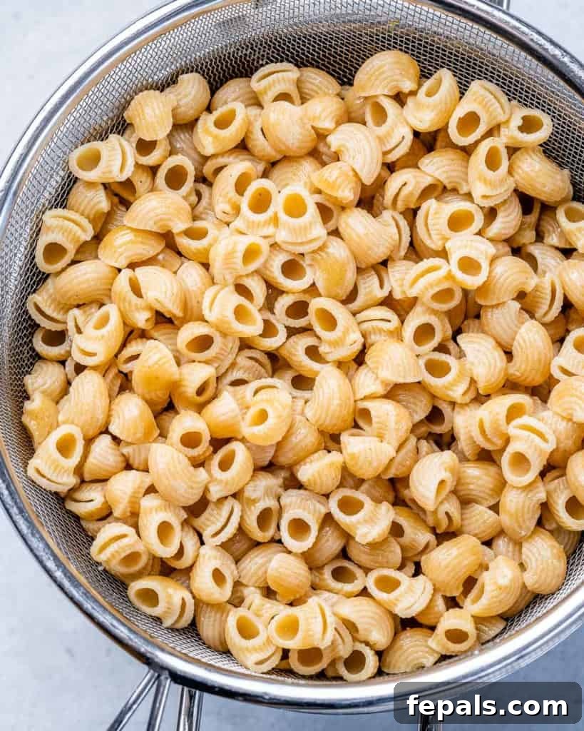 Grandma's Simple Macaroni Salad 5 cooked elbow macaroni in a white bowl, ready for mixing