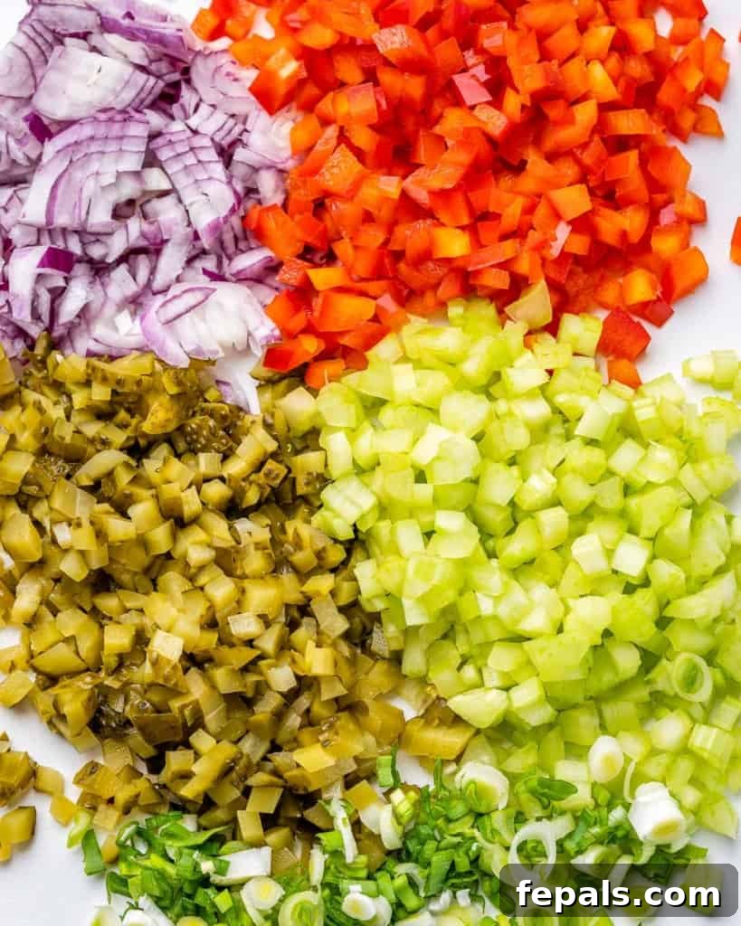 Grandma's Simple Macaroni Salad 6 bowl of freshly chopped vegetables including red bell peppers, celery, and red onion