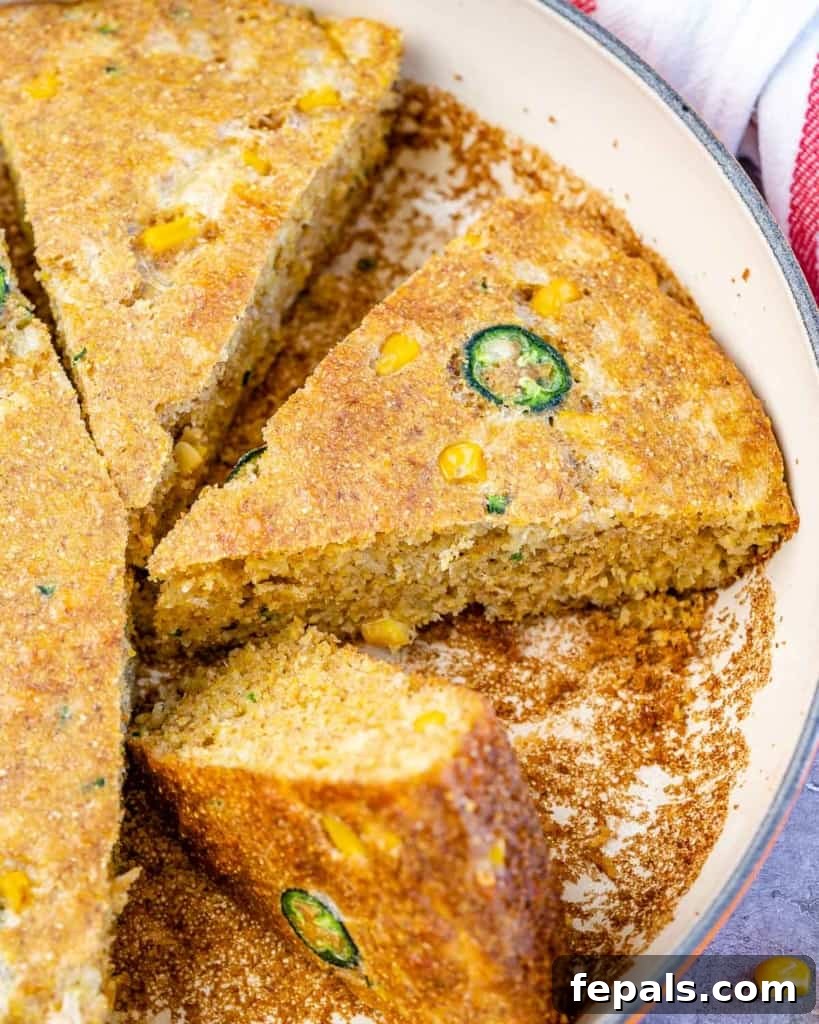 Three perfectly cut slices of savory Jalapeño Skillet Cornbread showcasing its moist texture and rich ingredients.