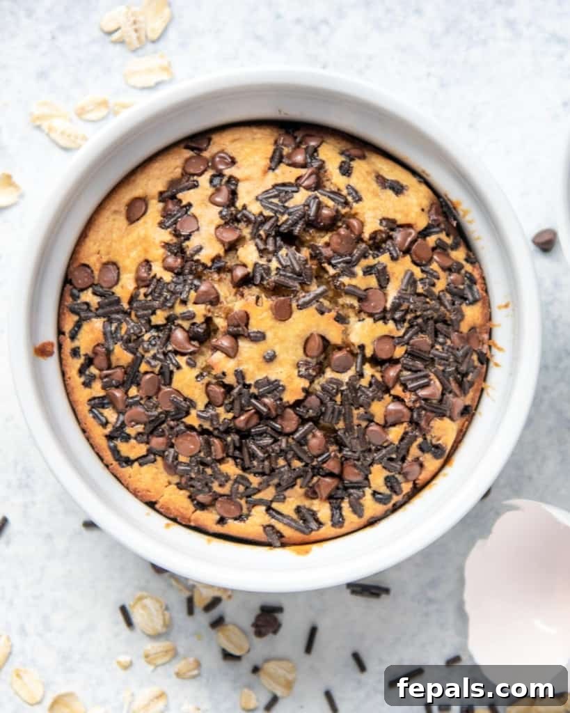 Chocolatey Baked Oatmeal Bliss 5 Top view of baked oats garnished with chocolate sprinkles, served in a white ramekin