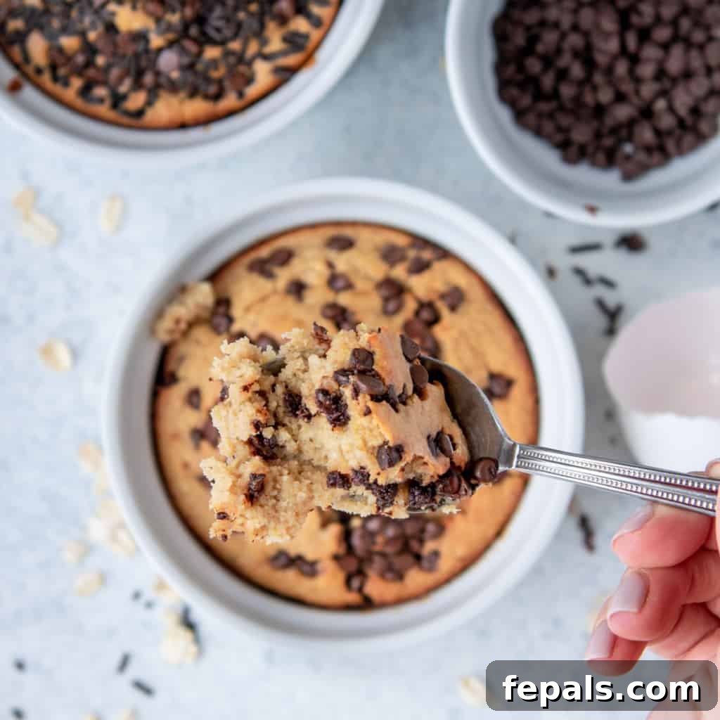 Chocolatey Baked Oatmeal Bliss 8 Hand holding a spoonful of chocolate chip baked oats, ready to eat