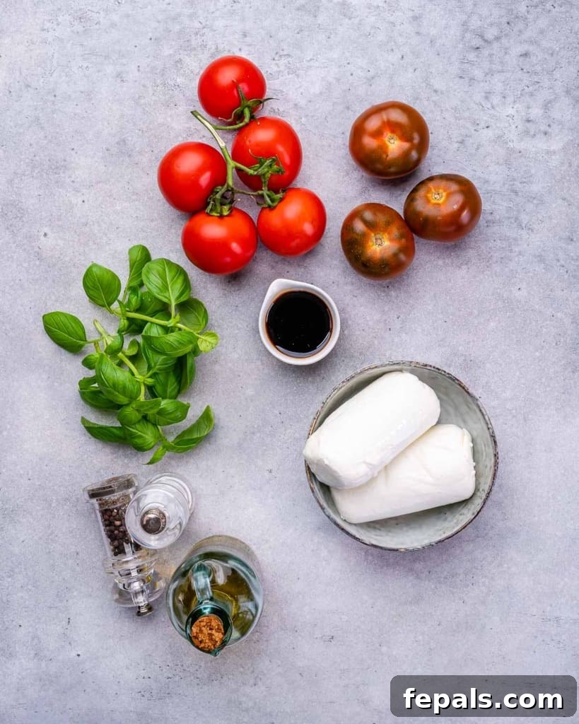 Effortless Caprese Perfection 4 Individual ingredients for Caprese salad laid out: salt, pepper, a bottle of balsamic glaze, fresh basil, sliced tomatoes, and a ball of fresh mozzarella.