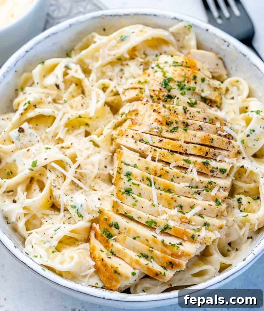 Creamy Chicken Fettuccine Bliss 2 top view chicken alfredo in a white bowl
