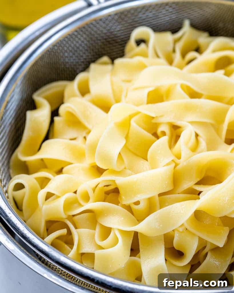 Creamy Chicken Fettuccine Bliss 4 close up cooked fettuccine pasta in colander
