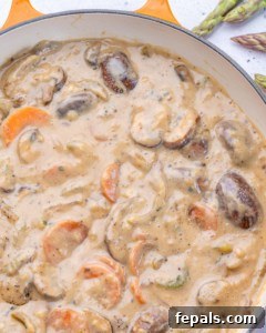 Top view of chicken chicken with mushrooms in pan