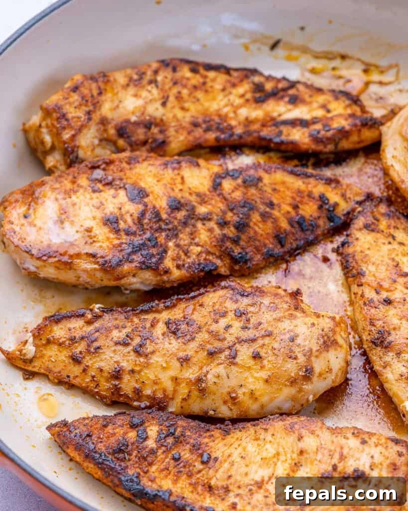 Velvet Chicken Supper 5 Golden-brown, seared chicken breasts resting in a pan, partially cooked and ready for the next step in making chicken fricassee.