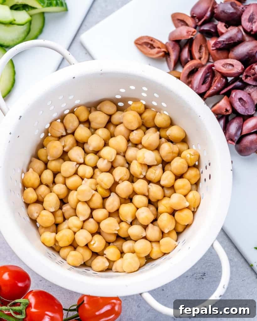 Zesty Greek Garbanzo Medley 6 chickpeas in a bowl with sliced kalamata olives