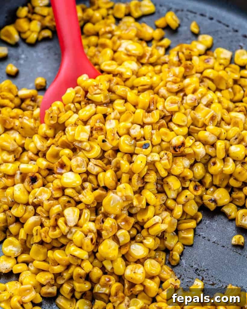 Zesty Fiesta Corn Salad 4 Ingredients being mixed in a bowl, showing the process of making the corn salad.