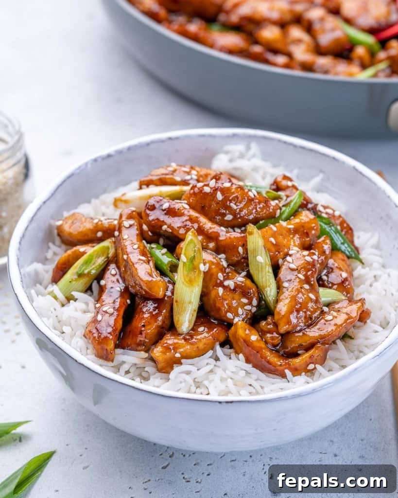 Sticky Garlic Mongolian Chicken 3 side shot asian chicken with rice in a white bowl