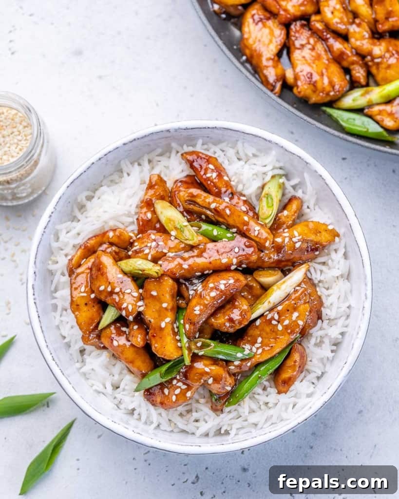 Sticky Garlic Mongolian Chicken 9 chinese chicken in a bed of rice in a white bowl