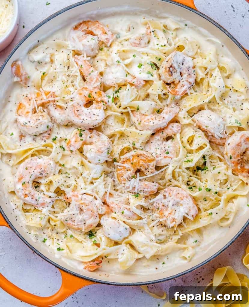 top view shrimp alfredo in an orange skillet