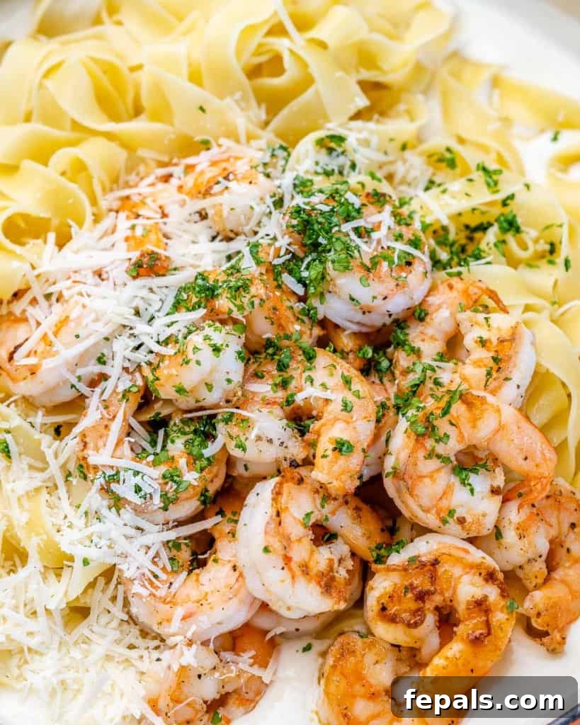 shrimp and sauce added over fettuccine pasta