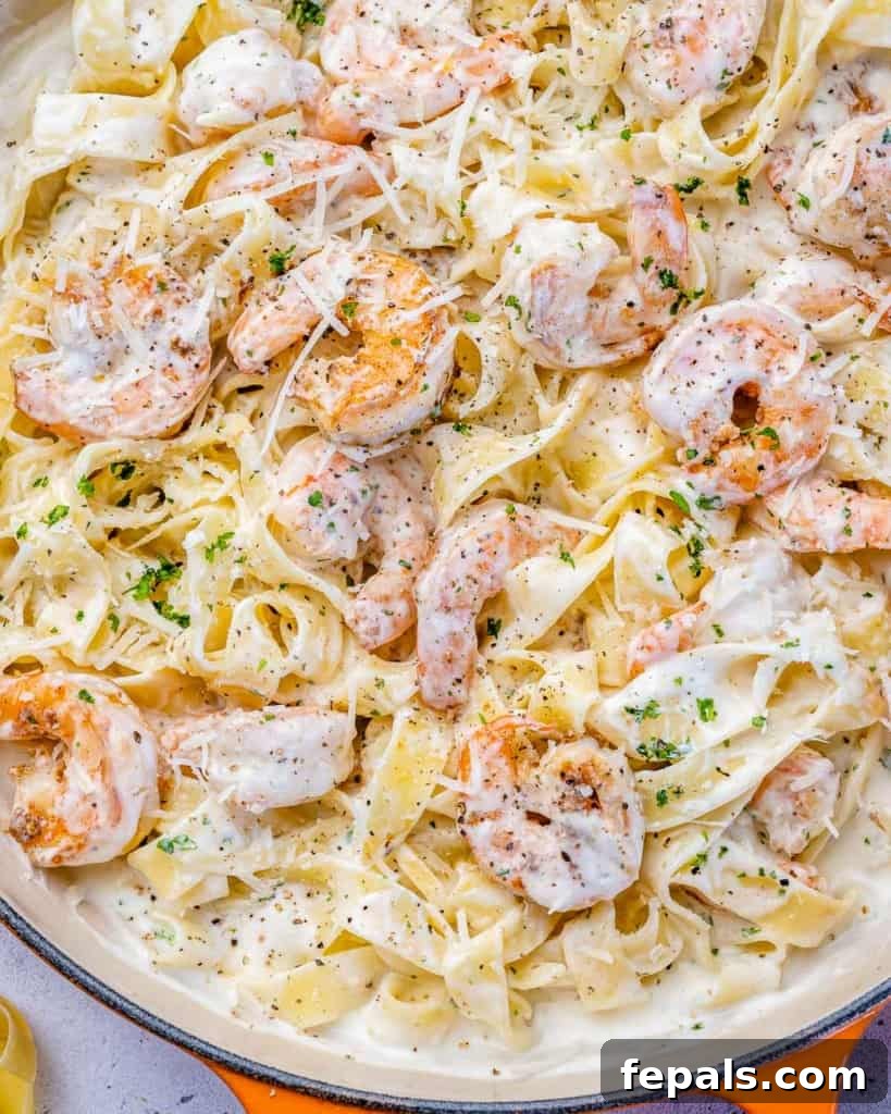close up shrimp alfredo in a skillet