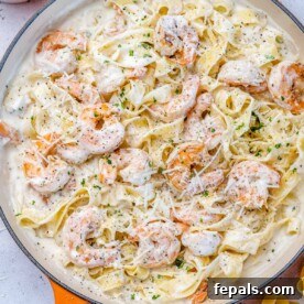 top view of shrimp alfredo in an orange skilet