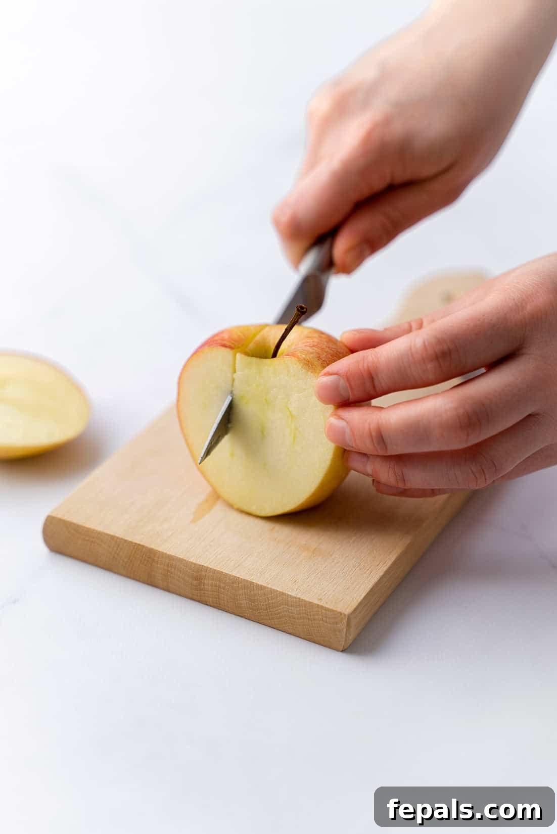 Easy Apple Coring with a Knife cutting off four slices of apple away from core, showing the process of removing all flesh