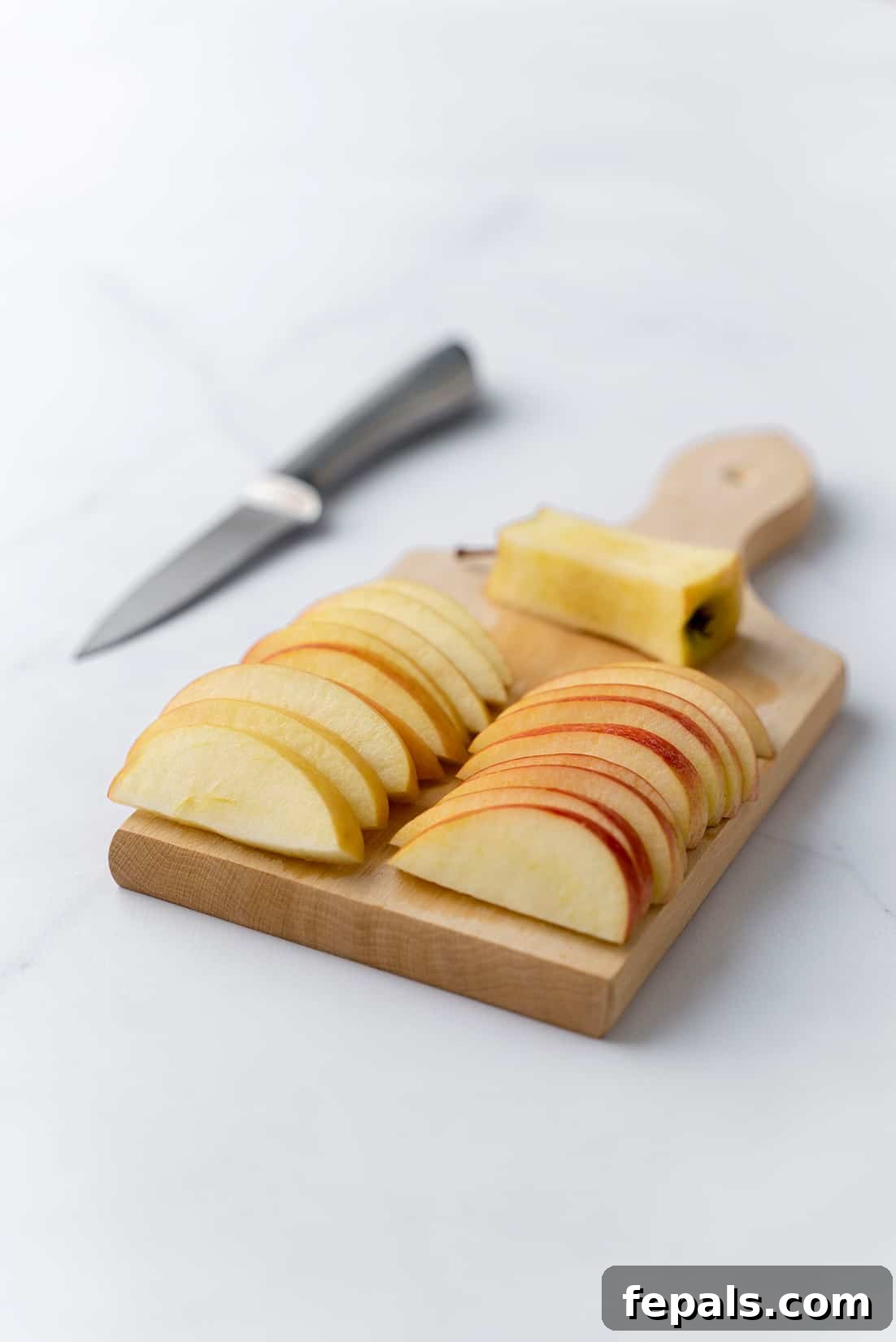 Prepared Apple Chunks for Slicing apple slices on wooden cutting board, neatly arranged after initial cuts