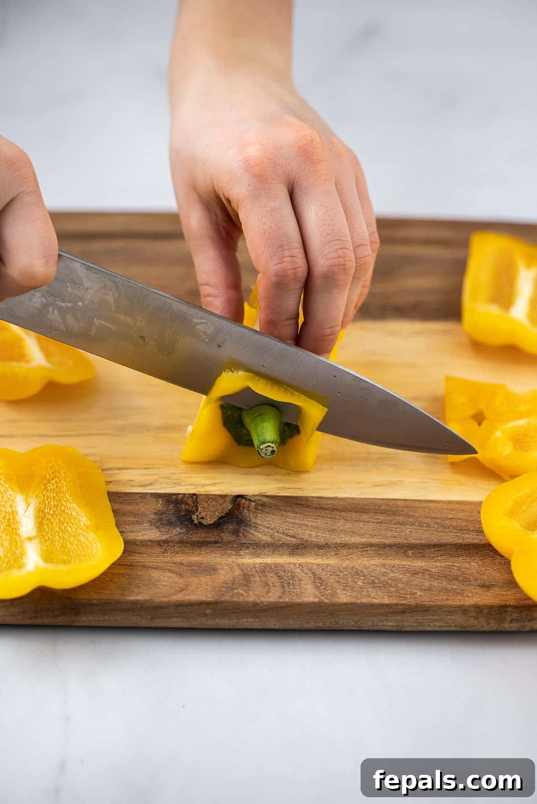 Master Bell Pepper Cutting Three Ways 16 The final cut removing the top section of the bell pepper, ensuring all parts are ready for dicing.