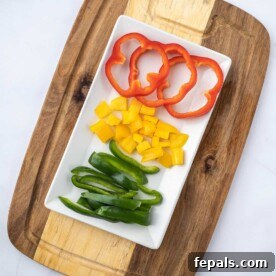 sliced bell peppers on white plate with cutting board