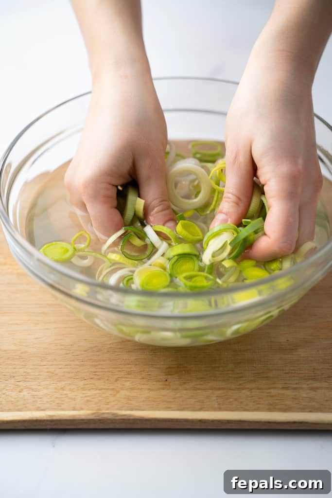 Mastering Leek Slicing 10 Leeks being washed in a bowl.