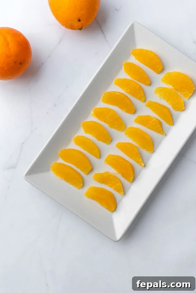 A platter of orange segments laid out, showcasing the beauty of supremed oranges.